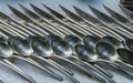 Spoons fork knife arranged on table as decoration pattern