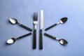 Spoons, fork and knife on color background Royalty Free Stock Photo