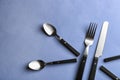 Spoons, fork and knife on color background Royalty Free Stock Photo