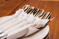 Spoons Forks and Knifes in Napkin Papers on Dishes Royalty Free Stock Photo