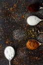 Spoons with icing sugar, green tea, coffee and cocoa on black background sprinkled with sugar, coffee, cocoa powder