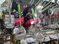Spoons, ladles and other cooking utensils are hung and displayed for sale.