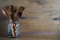 spoons and other wooden utensils in a jar on a wooden table Royalty Free Stock Photo