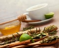Spoons with tea herbs, lime and honey Royalty Free Stock Photo