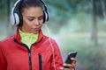 Sporstwoman choosing songs for jogging