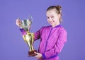 Sport achievement. Celebrate victory. Girl hold golden goblet. Importance of capturing evidence of kids progress. Proud