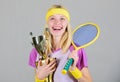 Sport achievement. Celebrate victory. Tennis champion. Athletic girl hold tennis racket and golden goblet. Win tennis