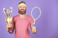 Sport achievement. Celebrate victory. Tennis champion. Athletic man hold tennis racket and golden goblet. Win tennis