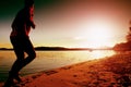 Sport active man running and exercising on the beach at sunset. Royalty Free Stock Photo