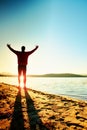 Sport active man running and exercising on the beach at sunset. Royalty Free Stock Photo