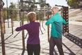 Sport activities in the early morning. Active mature family couple in sportswear exercising, doing sport together while