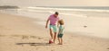 sport activity. glad father and son play football on beach. daddy with kid boy on summer day. Royalty Free Stock Photo