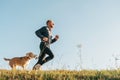 Sport activity with pet. Canicross exercises. Man runs with his