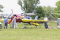 Sport airplanes standing on the landing field, people standing near