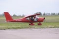 Sport airplanes standing on the landing field, people standing near