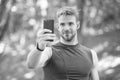 Sport app on phone. digital sport. smart watch. athletic man in sportswear make selfie. outdoor workout. Fitness app. Ui Royalty Free Stock Photo