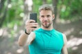 sport app on phone. digital sport. smart watch. athletic man in sportswear make selfie. outdoor workout. Fitness app. Ui Royalty Free Stock Photo