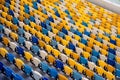 Sport arena empty tribune with colorful plastic seats.