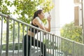 Sport Asian lady thirsty drinking water at morning jogging healthy lifestyle Royalty Free Stock Photo