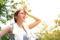 Sport asian woman gets tired and get dizzy, feel bad pain and suffer from heat stroke outdoors when jogging or exercise outdoor Royalty Free Stock Photo