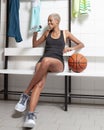 Sport basketball player in the locker room, a African American female athlete drinking water, before or after the game, Royalty Free Stock Photo