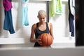 Sport basketball player in the locker room, a African American female athlete holding the ball before the game, competition or Royalty Free Stock Photo