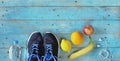 Sport, becoming fit and reducing weight for the spring, pair of runners, water and fruit,free copy space