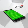 Sport betting online in app on mobile phone. Soccer field on smartphone screen. Sport betting banner on football ball background