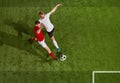 Two of football player in sportswear and football boots playing, training with ball over green grass field background Royalty Free Stock Photo