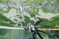 Sport bike and helmet standing near the lake in the mountains. Turisme in High Tatars. September 2020, Velicka Valley Royalty Free Stock Photo