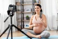 Happy pregnant woman blogger recording yoga video Royalty Free Stock Photo