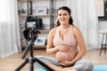 Happy pregnant woman blogger recording yoga video Royalty Free Stock Photo