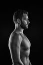 Sport bodybuilding and fitness concept. Bearded man athlete with fit torso in profile. Sportsman with muscular chest and belly. Bo