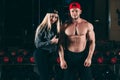 Sport, bodybuilding, weightlifting, lifestyle and people concept - Young beautiful couple in stylish clothes sitting a Royalty Free Stock Photo