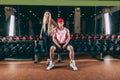 Sport, bodybuilding, weightlifting, lifestyle and people concept - Young beautiful couple in stylish clothes sitting a Royalty Free Stock Photo