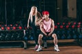 Sport, bodybuilding, weightlifting, lifestyle and people concept - Young beautiful couple in stylish clothes sitting a Royalty Free Stock Photo