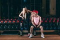 Sport, bodybuilding, weightlifting, lifestyle and people concept - Young beautiful couple in stylish clothes sitting a Royalty Free Stock Photo