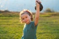 Sport child workout. Child exercising with kettlebell. Sporty child with dumbbell. Fit kids training. Child lifting the Royalty Free Stock Photo