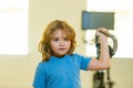 Sport child workout. Child exercising with dumbbells. Sporty child with dumbbell. Fit kids training. Royalty Free Stock Photo