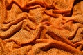 Sport clothing fabric texture background. Top view of orange polyester nylon cloth textile surface. Colored basketball shirt with Royalty Free Stock Photo