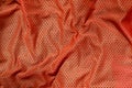 Sport clothing fabric texture background. Top view of red polyester nylon cloth textile surface. Colored basketball shirt with fr Royalty Free Stock Photo