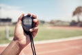 Sport, coach and closeup of hand with stopwatch for time, training and speed of athlete, runner or race. Mentor, trainer