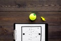 Sport coach concept. Pad with tactic plan of the match near whistle and tennis ball on wooden background top view copy Royalty Free Stock Photo