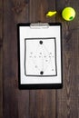 Sport coach concept. Pad with tactic plan of the match near whistle and tennis ball on wooden background top view copy Royalty Free Stock Photo