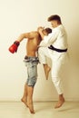 Sport and combat, karate athlete jumping, kicking knee at boxer Royalty Free Stock Photo