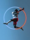 Creative artwork of prfessional male football player in motion over neon geometric element isolated on blue background