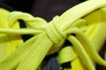 Sport concept, shoe close up, wellness concept, yellow lace on blue sneakers close up. Detail of yellow shoe on running shoes. Royalty Free Stock Photo