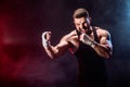 Sportsman muay thai boxer fighting on black background with smoke. Royalty Free Stock Photo