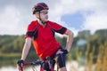 Sport Concepts. Concentrated Male Cyclist Relaxing with Road Bicycle Equipped with Professional Outfit Outdoors on Nature Royalty Free Stock Photo