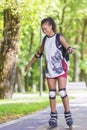 Sport Concepts. Young African American Teenage Girl Learning Roller Skating in Park Area